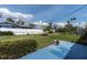 View of fenced backyard, showcasing the well-maintained lawn, tropical landscaping, and outdoor space at 16315 2Nd E St, Redington Beach, FL 33708