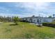 Backyard featuring lush green lawn, partial privacy fence and landscaping, creating a relaxing outdoor oasis at 16315 2Nd E St, Redington Beach, FL 33708