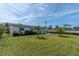 Expansive backyard features a well-maintained lawn, tropical landscaping, and privacy fencing at 16315 2Nd E St, Redington Beach, FL 33708
