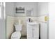 Cozy bathroom showcasing white tiled walls, a toilet and a sink with a cabinet at 16315 2Nd E St, Redington Beach, FL 33708