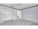 A light blue bedroom with a ceiling fan and an open closet offering ample storage at 16315 2Nd E St, Redington Beach, FL 33708