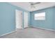 A bedroom with light blue walls featuring two entry doors and a window at 16315 2Nd E St, Redington Beach, FL 33708