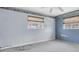 Bedroom featuring two windows with shades and light blue and dark blue accent walls at 16315 2Nd E St, Redington Beach, FL 33708