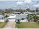 Charming single-story home with a two-car garage, well-maintained lawn, and mature landscaping at 16315 2Nd E St, Redington Beach, FL 33708