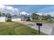 Charming single-story home with a well-manicured lawn, driveway, and attached two-car garage at 16315 2Nd E St, Redington Beach, FL 33708