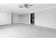 Living room with open floor plan, vintage ceiling fan, and neutral color palette at 16315 2Nd E St, Redington Beach, FL 33708