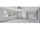 Expansive living room with large window, ceiling fan, and unique vertical molding at 16315 2Nd E St, Redington Beach, FL 33708