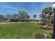 Expansive green lawn with scattered trees, benches, and walking paths in a peaceful park setting at 16315 2Nd E St, Redington Beach, FL 33708