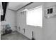 Utility room with window, storage shelf and gray concrete walls at 16315 2Nd E St, Redington Beach, FL 33708