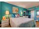 Comfortable bedroom featuring turquoise walls, two nightstands, white comforter, and plush pillows at 1847 Shore Drive South # 308, South Pasadena, FL 33707