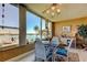 Charming breakfast nook with serene water view and elegant white wicker furniture at 1847 Shore Drive South # 308, South Pasadena, FL 33707