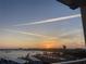Scenic city and water view with a vibrant sunset and many airplane contrails in the sky at 1847 Shore Drive South # 308, South Pasadena, FL 33707