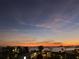 Evening city view featuring a body of water reflecting lights under a colorful sky at 1847 Shore Drive South # 308, South Pasadena, FL 33707