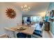 Elegant dining area with chandelier, decor and a glimpse of the waterfront view at 1847 Shore Drive South # 308, South Pasadena, FL 33707
