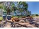 Enjoy outdoor relaxation with picnic tables and grills on the community patio, shaded by trees and umbrellas at 1847 Shore Drive South # 308, South Pasadena, FL 33707