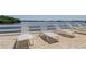 Bay view with lounge chairs for outdoor relaxation, perfect for enjoying sunny days and serene waterfront scenery at 1847 Shore Drive South # 308, South Pasadena, FL 33707