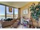 Bright sitting area with water view, decorative elements, and comfortable wicker furniture at 1847 Shore Drive South # 308, South Pasadena, FL 33707