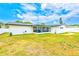 Spacious backyard showcasing a well-kept lawn, white privacy fence, and screened-in porch at 1851 Glenville Dr, Clearwater, FL 33765