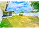 Expansive backyard with a well-manicured lawn and a white fence providing privacy at 1851 Glenville Dr, Clearwater, FL 33765