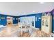 Bright dining room with wood floors, dark blue accent wall, and stylish wooden table set at 1851 Glenville Dr, Clearwater, FL 33765