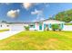 Charming one story home with colorful shutters, landscaped yard, and a white exterior at 1851 Glenville Dr, Clearwater, FL 33765