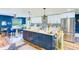 Open-concept kitchen with a large island, stainless steel appliances, and ample cabinet space at 1851 Glenville Dr, Clearwater, FL 33765
