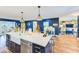 Large island with stainless steel appliances, white cabinets, and pendant lighting at 1851 Glenville Dr, Clearwater, FL 33765