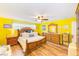 Sun-filled main bedroom with wood floors, ceiling fan, and classic wooden furniture at 1851 Glenville Dr, Clearwater, FL 33765
