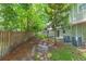 Lush backyard featuring mature trees, wood fence, and the exterior of the home at 220 Sawtooth Dr, Valrico, FL 33594