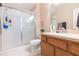 Well-lit bathroom featuring a glass shower and vanity with warm wood cabinets at 220 Sawtooth Dr, Valrico, FL 33594