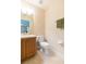 A cozy bathroom features a toilet, vanity with sink, and neutral-toned walls and floors at 220 Sawtooth Dr, Valrico, FL 33594