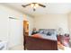 Comfortable bedroom features a ceiling fan, soft lighting, and an attached bathroom at 220 Sawtooth Dr, Valrico, FL 33594
