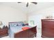 A relaxing bedroom features a ceiling fan and soft lighting at 220 Sawtooth Dr, Valrico, FL 33594
