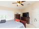 Bedroom featuring a ceiling fan, with dresser, bed, and window with natural light at 220 Sawtooth Dr, Valrico, FL 33594