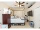 Well-lit bedroom with a four-poster bed, ceiling fan, and a large flat screen TV at 220 Sawtooth Dr, Valrico, FL 33594