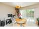 Bright dining area featuring a charming round table, stylish chandelier, and sliding door access to the outdoors at 220 Sawtooth Dr, Valrico, FL 33594