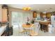Cozy dining area with a round table, modern lighting, and views extending into the kitchen area at 220 Sawtooth Dr, Valrico, FL 33594