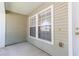 Front porch with white trim and neutral siding at 220 Sawtooth Dr, Valrico, FL 33594