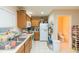Functional kitchen with wooden cabinetry, a stainless steel sink, and convenient access to the bathroom at 220 Sawtooth Dr, Valrico, FL 33594