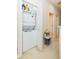 Hallway view of a stacked washer and dryer unit nestled into a closet at 220 Sawtooth Dr, Valrico, FL 33594
