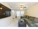 Comfortable living room featuring a large flat-screen TV, neutral walls, and a cozy green sofa at 220 Sawtooth Dr, Valrico, FL 33594