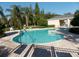 Community pool with paved patio area, lush trees, and well-maintained landscaping at 220 Sawtooth Dr, Valrico, FL 33594
