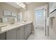 Bathroom boasts double sink granite vanity with gray cabinets and decor at 2904 W Averill Ave, Tampa, FL 33611