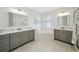 Luxurious bathroom features dual vanities, a soaking tub, tiled floors, and modern fixtures at 2904 W Averill Ave, Tampa, FL 33611