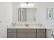 Bathroom with granite countertop, modern fixtures, framed mirror and artwork at 2904 W Averill Ave, Tampa, FL 33611