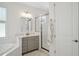 Bright bathroom featuring a tiled shower, soaking tub, and granite vanity with modern fixtures at 2904 W Averill Ave, Tampa, FL 33611
