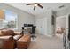 Spacious bedroom featuring a chair, a desk with computer monitors, and a view into the hallway at 2904 W Averill Ave, Tampa, FL 33611