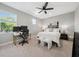 Bedroom featuring modern ceiling fan, desk and chair, and queen sized bed at 2904 W Averill Ave, Tampa, FL 33611
