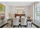 Tastefully decorated dining room with a wooden table, upholstered chairs, elegant chandelier, and stylish decor at 2904 W Averill Ave, Tampa, FL 33611