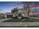 Charming two-story home featuring meticulously manicured landscaping with a gray two-car garage at 2904 W Averill Ave, Tampa, FL 33611